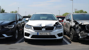 Totaled cars parked in a lot waiting for insurance claim evaluation