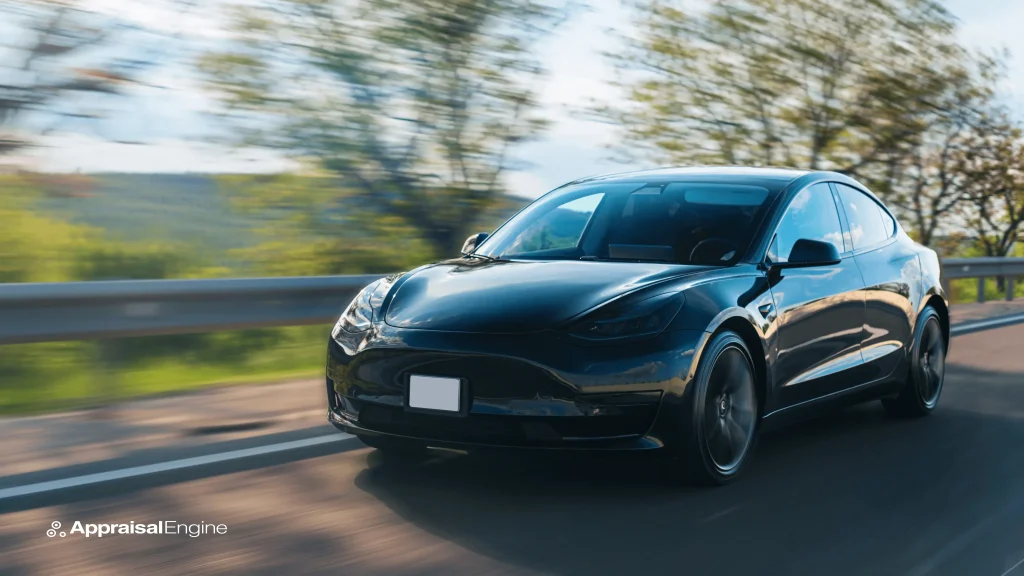 A black Tesla Model Y in motion, elegantly cruising on a highway with a blurred green landscape in the background, exemplifying the blend of luxury, performance, and sustainable technology.