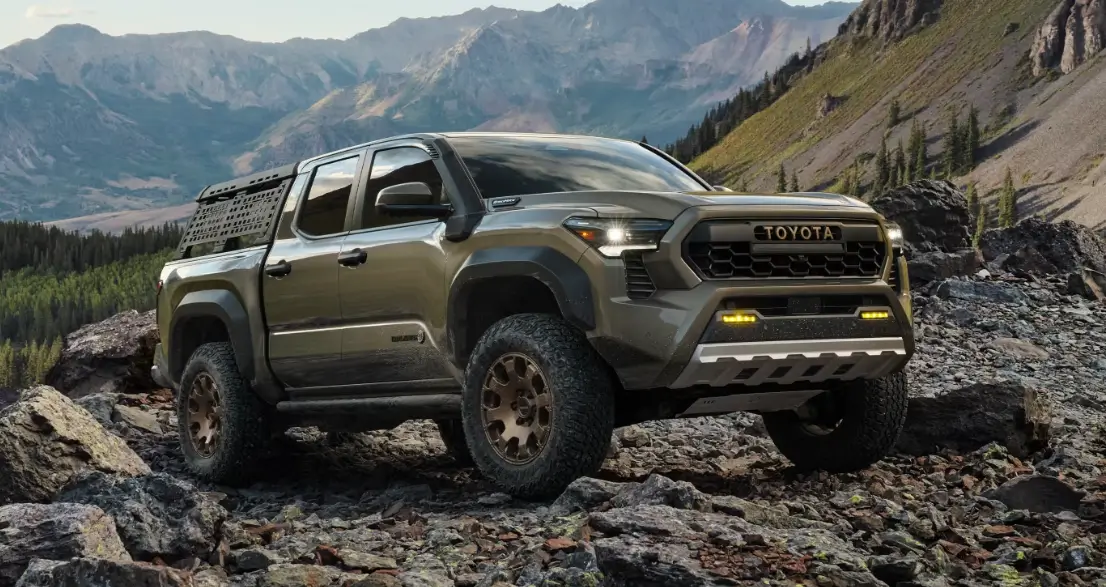 Toyota pickup truck navigating through a rocky mountain landscape, emphasizing its durability and off-road prowess.