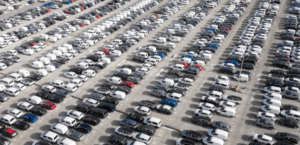 Aerial view of hundreds of parked cars showing the aging U.S. vehicle fleet affecting total loss value