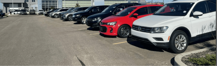 Row of certified pre-owned vehicles parked on a dealership lot