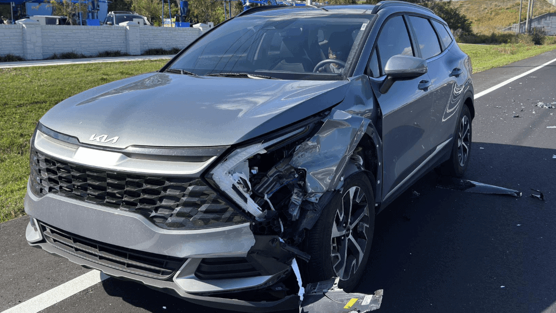 Electric Kia with front-end damage after a collision during repair estimate evaluation