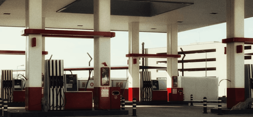 Empty fuel station with rows of gas pumps, illustrating how sustained gas prices are reshaping used car values