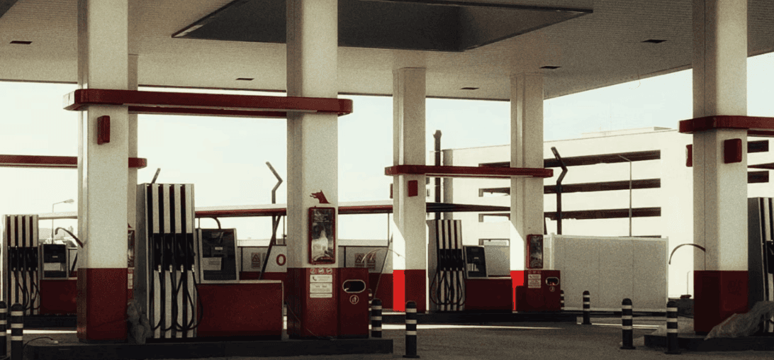 Empty fuel station with rows of gas pumps, illustrating how sustained gas prices are reshaping used car values