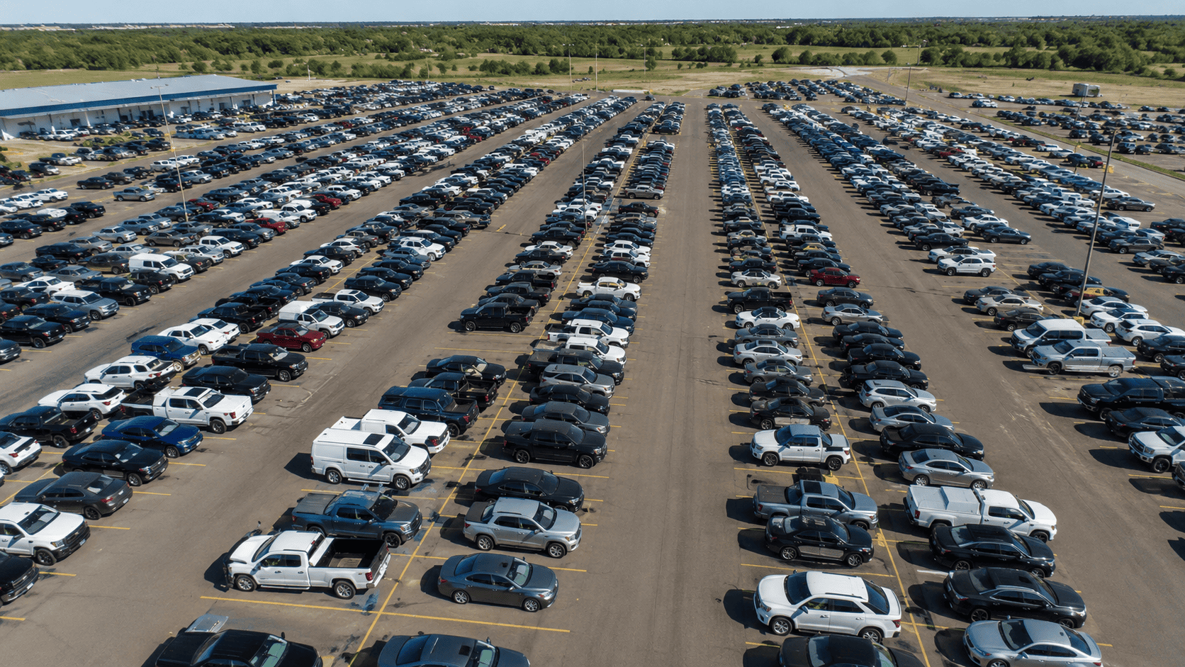 Aerial view of a large used vehicle auction lot with rows of cars, trucks and SUVs, illustrating used vehicle depreciation trends in 2026